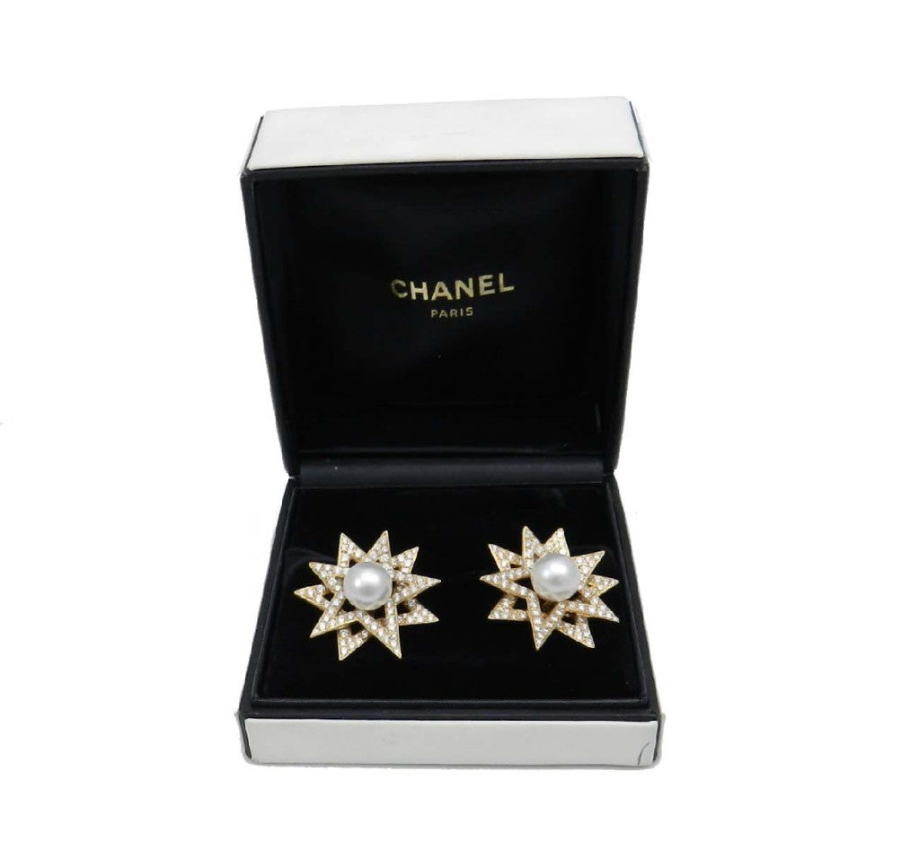 18kt. yellow gold  Chanel double star earrings. Each of the earrings is bead set with 103 round brilliant cut diamonds totaling approx. 7 cts. grading VS clarity E-G color , each center is set with a round south sea pearl measurin g approx. 12.5
