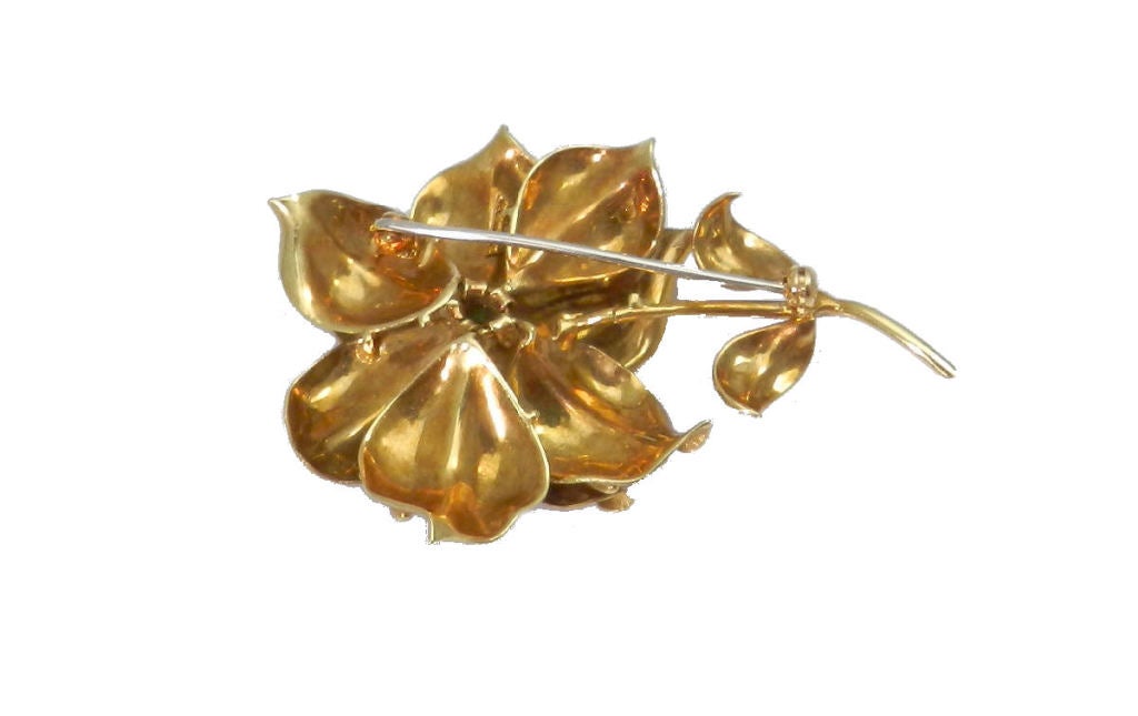 Everyday wearable Tiffany & Co. natural turquoise center flower brooch in a matt 18kt. yellow gold background with high finish detail. The pin measures 2 1/2 