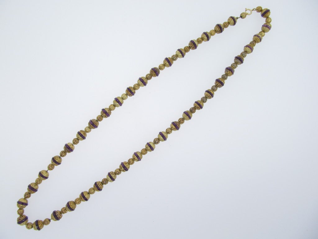 Distinctive antique 14kt. yellow gold strand of handmade Victorian Etruscan Revival 9.5 mm. wire work beads with faceted amethyst centers with 6 mm. alternating beads. The beads are strung on gold chain. The strand measures 26