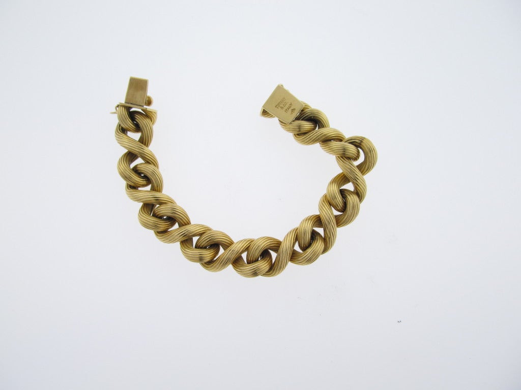 Ladies 18kt. yellow gold heavy solid link bracelet with double- sided ribbed design curb links. Signed Tiffany & Co.