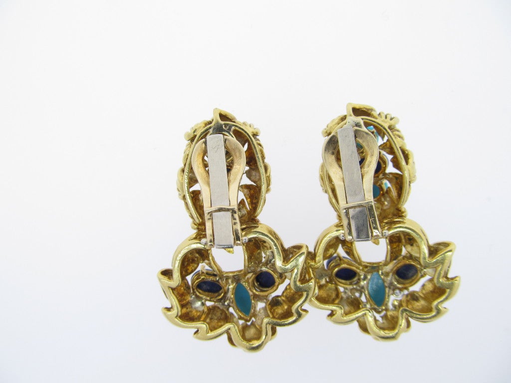 Handmade leaf design 18kt. yellow gold door knocker style earrings. Each earring is set with natural robin egg turquoise and lapis lazuli, accented with 2 prong set round brilliant cut diamonds. Clip back, posts may be added.