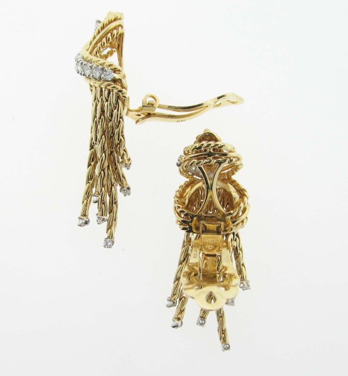Wonderful 14kt. yellow gold clip back diamond tassel earrings. Each earring is prong set in white gold with 17 round brilliant very fine diamonds with diamonds at the end of each tassel totaling approx. .80cts. Posts may be added.