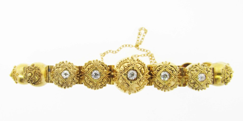 A terrific example of Victorian Etruscan handmade jewelry in great condition. The 15kt. yellow gold  wire work tapered ball diamond top bracelet is bead set with 5 old mine cut diamonds across the top totaling approx. .40cts. circa 1880.