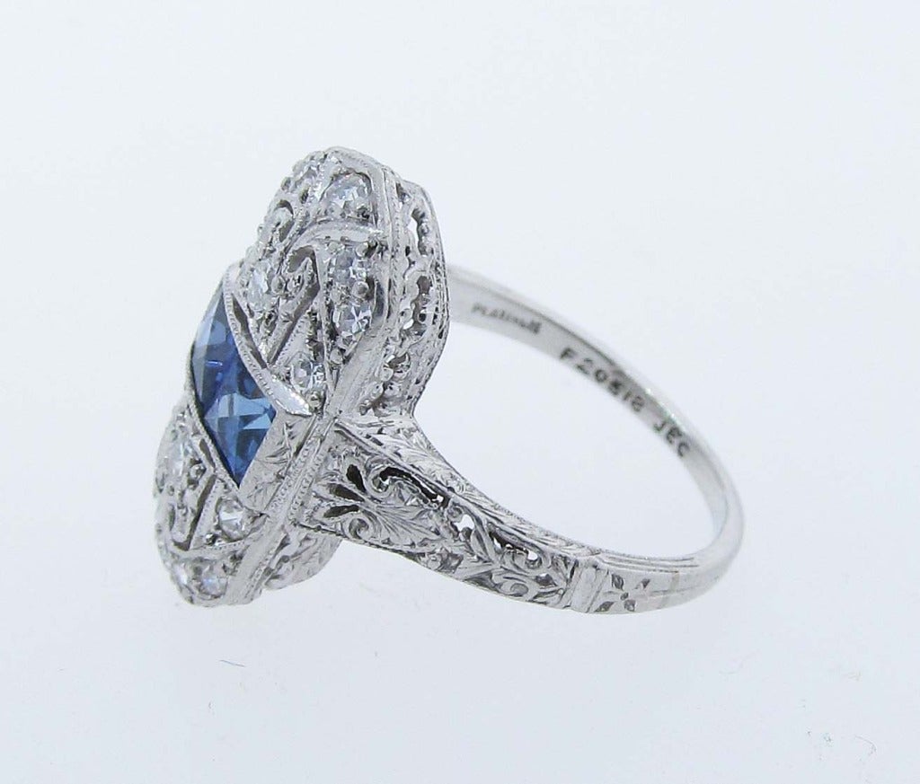 Pretty Art Deco handmade platinum mount dinner style ring. Set in the center with two natural French cut sapphires totaling approx.50cts. The open engraved pierced mount is also set with 8 round European cut diamonds totaling approx..35cts. Circa