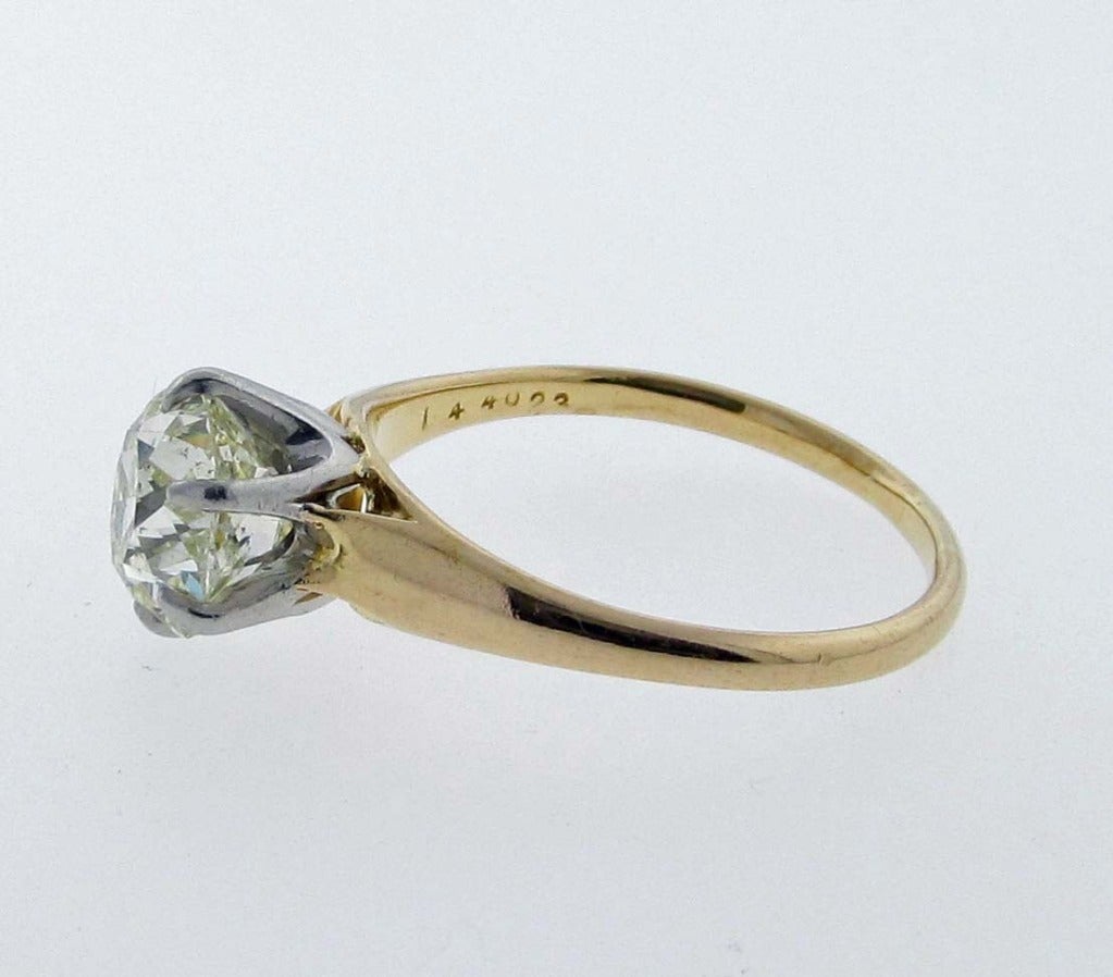 Antique cushion cut diamond ring circa 1880 in a two tone 18kt. handmade mount. The diamond measures 8.8 mm. x 7.75 mm. x 5.55mm. weighing approx. 2.5cts. grading a warm Cape color Si1 clarity . Only the old cuts have the 