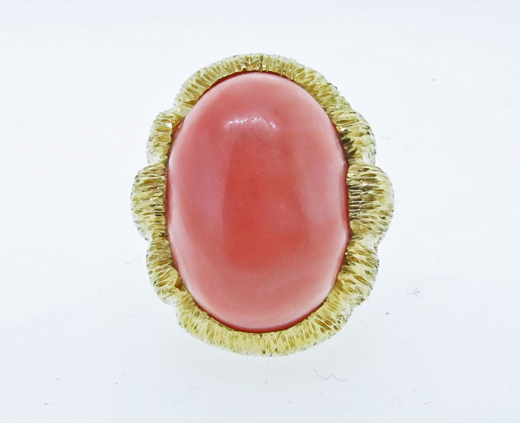 Impressive 18kt. yellow gold bark finish oval coral ring The coral measures approx.  23.5 mm. x  17.5mm. x  9.5mm. the ring is size 6 1/2.