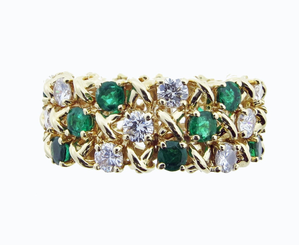 Classic  Tiffany & Co. 9.5 mm. wide 18kt. yellow gold band. There are 18 round brilliant cut diamonds totaling approx. 1.ct.  alternating with 18 round faceted fine color natural emeralds totaling approx..80cts. prong set three rows. The ring is