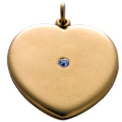 Gold heart locket with diamond.