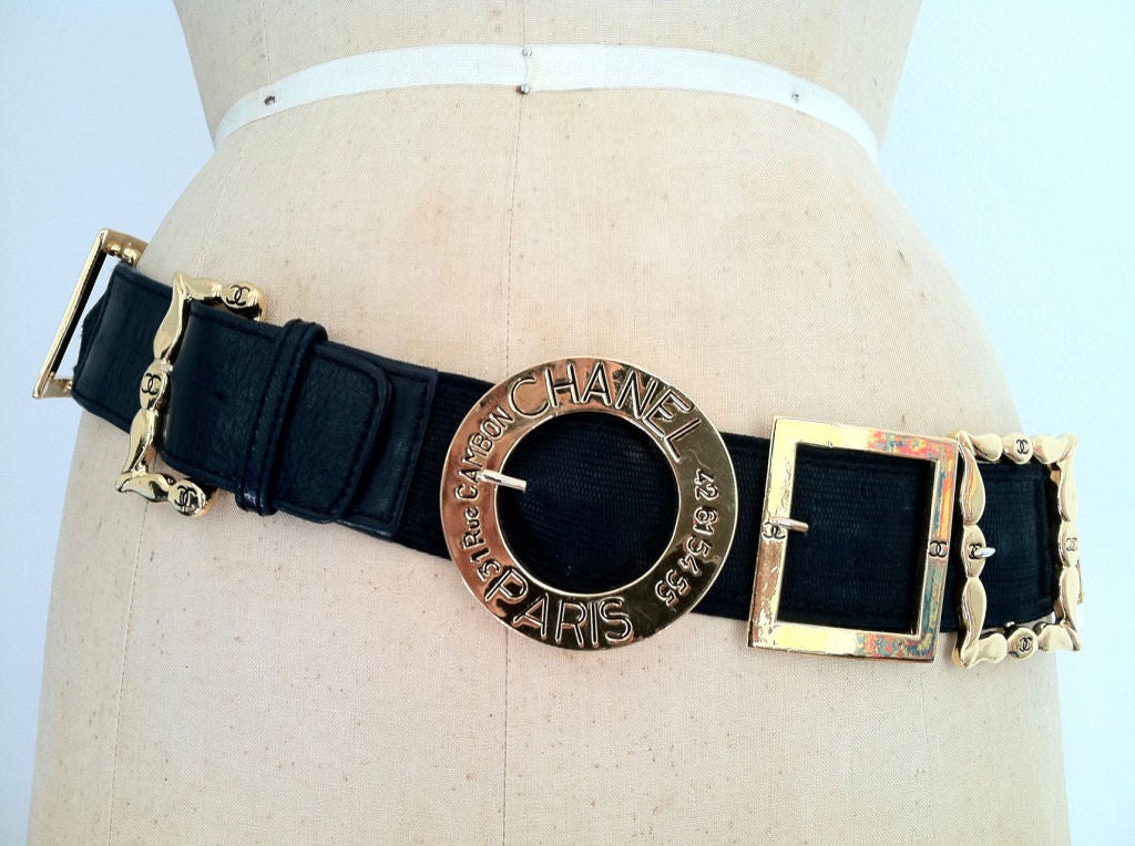 Fine vintage Chanel 'buckles' belt. Authentic signed item features 14 large gilt metal Chanel buckles. Buckles mounted on a elastic belt with leather ends.