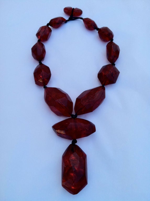 Fine vintage resin necklace. Large red unsigned hand carved beads on cord with large center 'drop'.