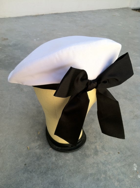 Fine vintage Chanel beret. Authentic white cotton twill item with black silk satin trim & attached bow.