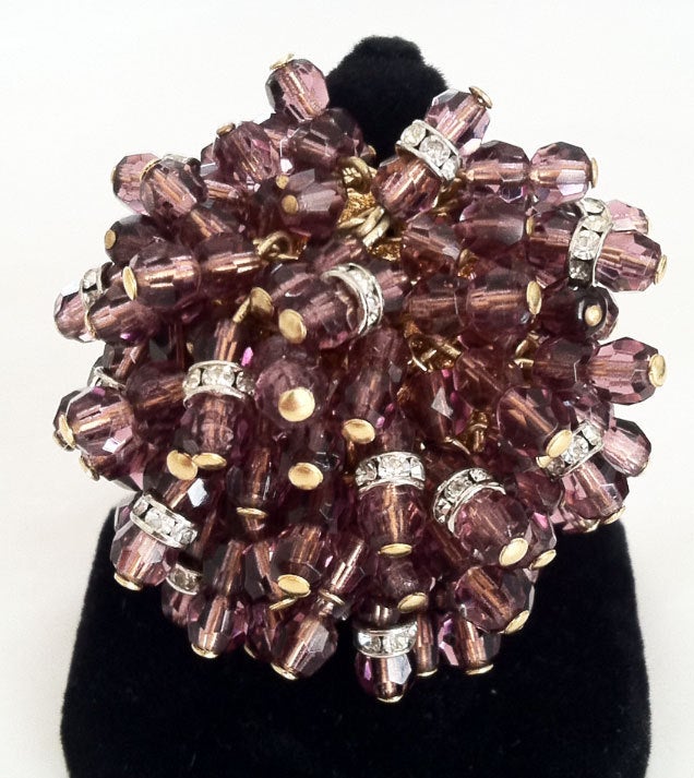 Fine vintage William de Lillo crystal cocktail ring. Large signed gilt metal item features fringed 'amethyst' & Swarovski crystals. Adjustable 1 size all.

William de Lillo (deceased 2011) was born in Belgium and came to the United States in the