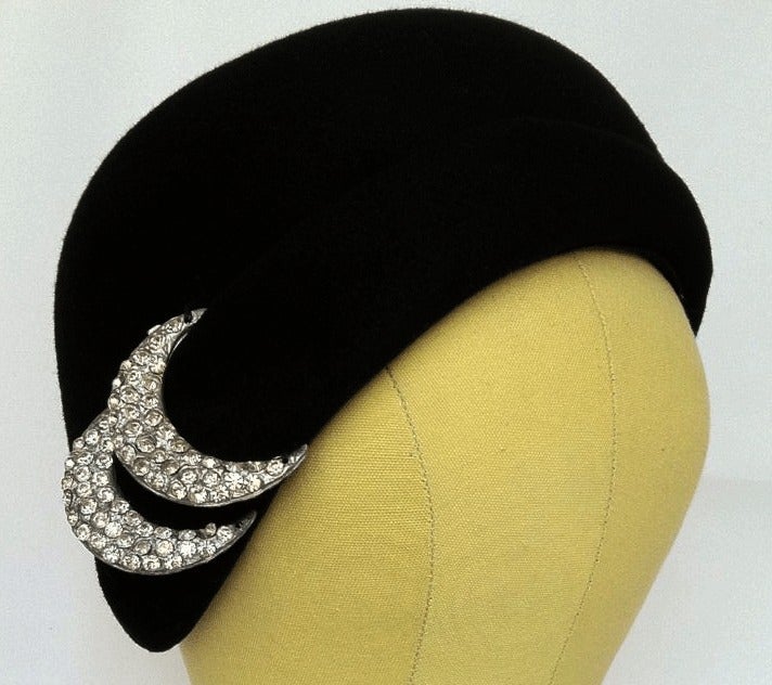 Fine vintage Halston cloche hat. Authentic sculpted black wool felt item features an attached pave crystal set decoration.