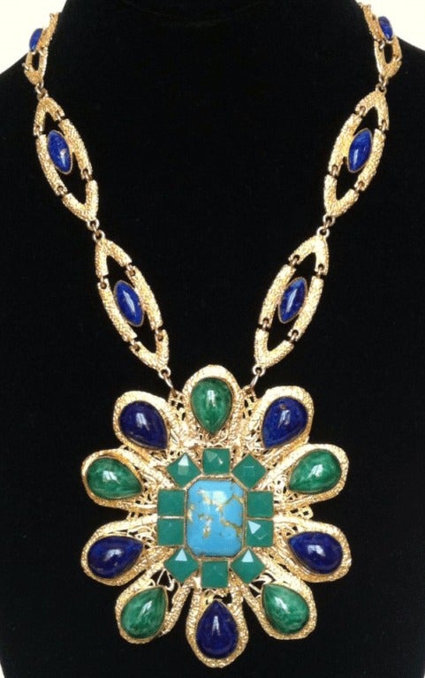 Fine vintage William de Lillo pendant necklace. Signed gilt metal link item with large pendant brooch. Item features faux turquoise, Lapis and jade cabochons and faceted 'jade' crystals. Original hidden push clasp closure. Outstanding design and