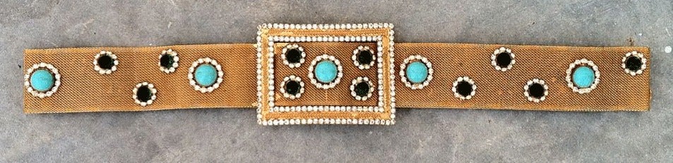 A fine vintage William de Lillo 'jeweled' belt. Signed gilt metal mesh item with various colored bezel set cabochons with Swarovski crystal surrounds. Item features hidden hook closures.

William de Lillo (deceased 2011) was born in Belgium and