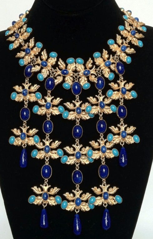 Fine and impressive vintage William de Lillo Bib necklace. Gilt metal cascading link item features faux 'Lapis' and 'turquoise' art glass cabochons and drops. Original hook closure intact. Outstanding design and execution appropriate for any