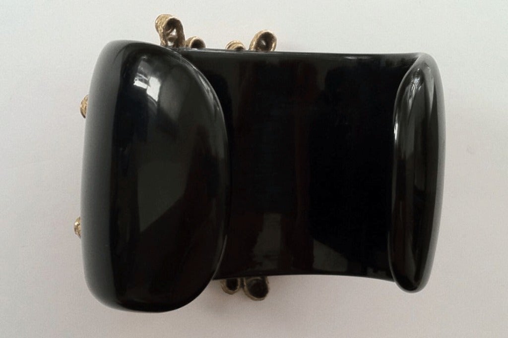 Iconic vintage Chanel cuff bracelet. Rare black bakelite cuff with gilt metal 'starburst' set with crystal and a Gripoix red 'poured' glass center. Unsigned. A rare item appropriate for any collection!