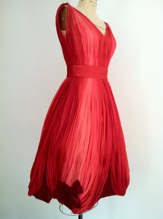 A rare vintage Sophie Gimbel Couture cocktail dress. A stunning original design for the actress/mode/singer Joan Kemp (custom Saks Fifth Avenue order tag dated 9-13-60). Beautifully draped and pleated vivid pink to raspberry silk ombre chiffon
