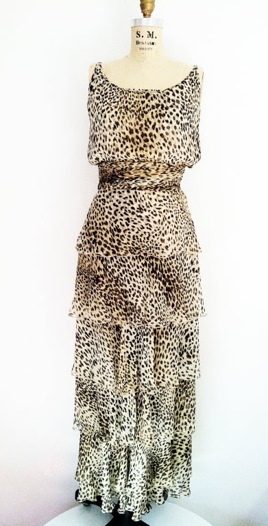 A fine vintage Valentino silk gown. Gorgeous tiered leopard print silk chiffon item features an attached matching fabric ruched waist line. Item fully lined and zips up side.