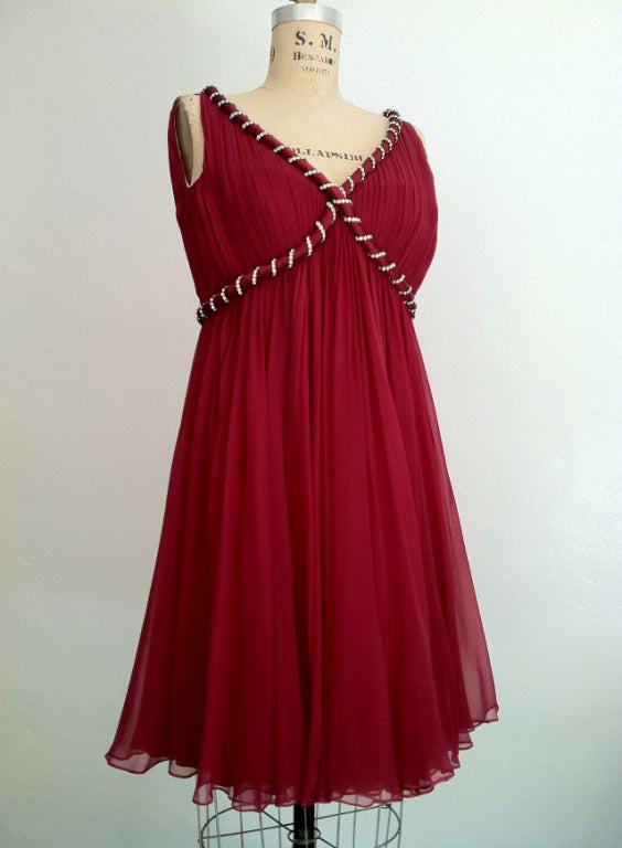 A fine and rare vintage Malcolm Starr babydoll evening mini dress. Exquisite burgundy silk chiffon item features a 