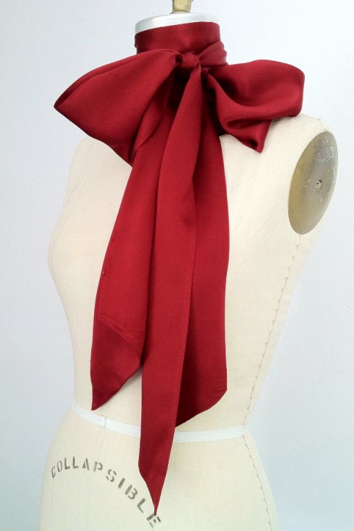 A fine vintage Chanel silk tie/sash/bow. Burgundy silk satin item with pointed ends. Item can be worn as a bow, tie or sash belt.