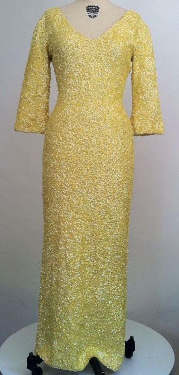An vintage classic of the now infamous 1950s knit gowns made famous by such icons as Marilyn Monroe etc! A fantastic sunshine yellow wool knit version completely covered in aurora yellow sequins, neckline to hem.