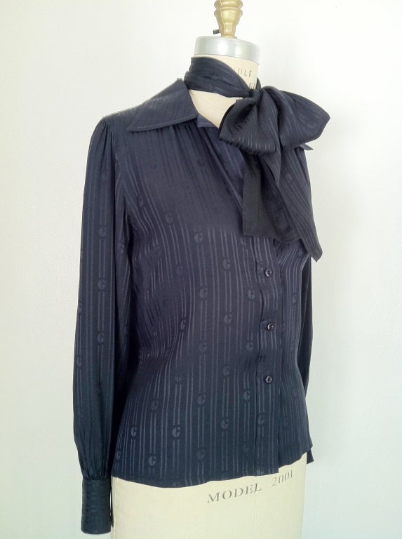 A fine vintage Givenchy silk blouse and matching tie. Fine navy logo silk jacquard fabric item features a button front, spread collar and matching tie (or belt). Authentic item for I. Magnin.