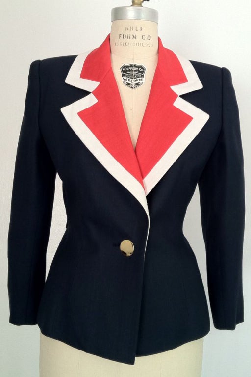 A fine vintage Givenchy 'patriotic' jacket. Fitted navy blue silk linen weave item with contrasting large notched collar. Item fully silk lined with attached back half belt and large gilt metal buttons.