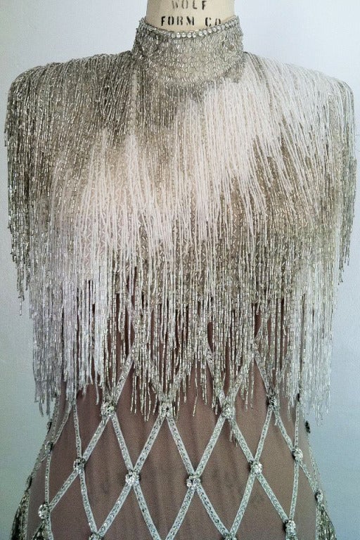 A stunning vintage Bob Mackie Couture fringed beaded column gown. Outstanding one-off custom item for a French lady. Silk jersey item features crystal fringe beaded bodice and skirt with crystal 'lattice' nude illusion waist with Swarovski crystal