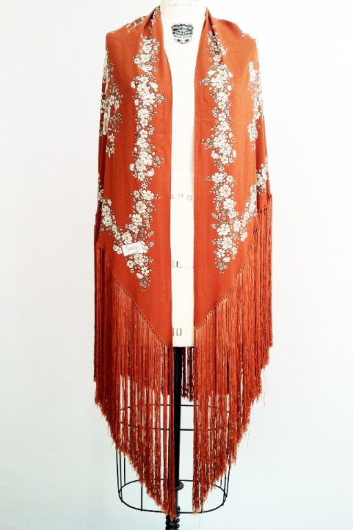 A fine vintage Gucci piano fringe wrap scarf. Gorgeous silk floral print item trimmed in matching color silk fringe.