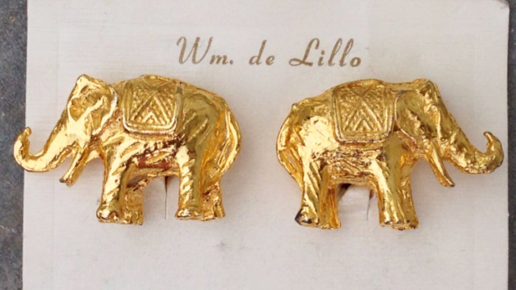 A fine vintage pair William de Lillo figural ear clips. Signed gilt metal 