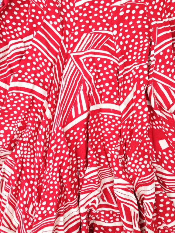 A fine and rare vintage Biba 'art deco' print pleated skirt. Charming red print on tan background. Item zips up side. Excellent.