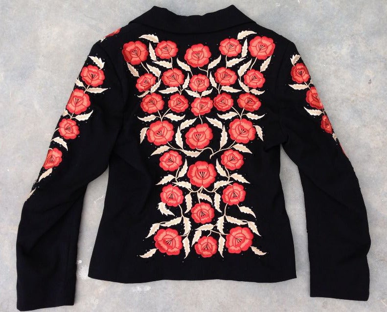 A fine and rare vintage Manuel limited numbered (67 of 100) embroidered jacket. Fitted black gabardine item fully floral embroidered with black crystals and fully silk lined.