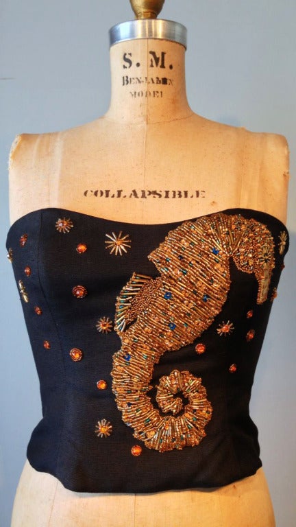 A fine and rare vintage Christian Dior 'seahorse' embellished jacket and matching bustier. Exquisitely gold crystal beaded items on black linen weave fabric. Matching boned bustier with zipper closure. Both items fully silk lined.