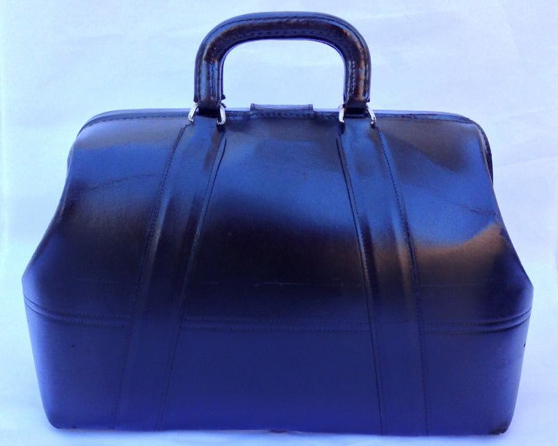 A fine vintage Dr. bag/satchel. Black leather item retains original art deco style plated lock closure (operates with no key) and glides.