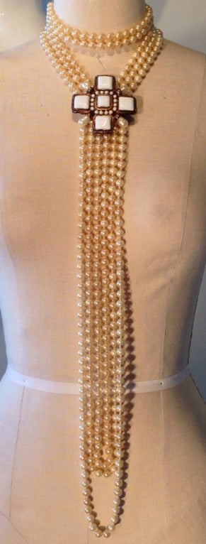 A rare vintage Chanel 2001 runway necklace. Signed multi-strand faux pearl item features a gilt cross set with Gripoix white 'poured' glass and matching pearl mounts. Double hook closures.