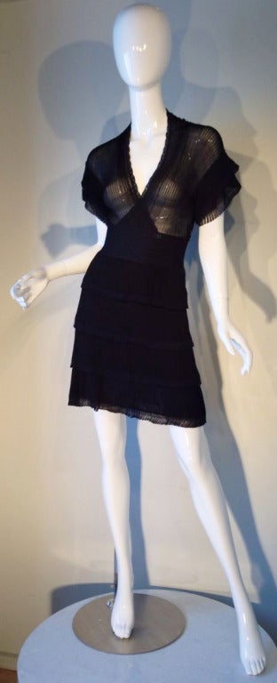 A fine Chanel knit cocktail dress. Sheer bodice with a tiered skirt. Item zips up side. Size tag 36.
