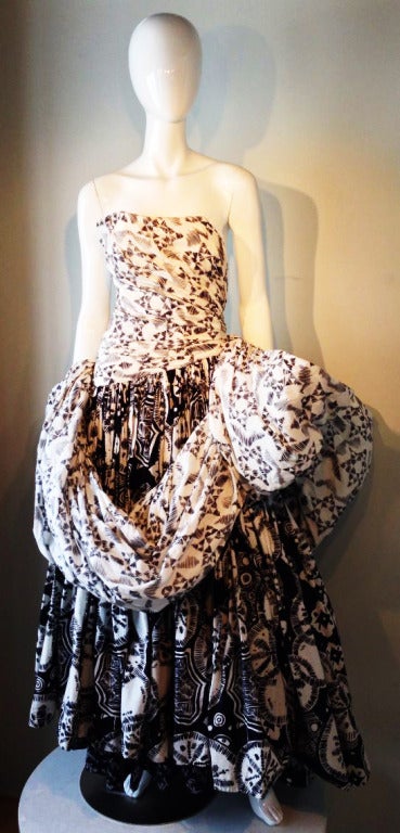 A fine and rare vintage Louis Feraud haute couture gown. A dynamic black and white cotton print is used to great effect. Slim ruched boned bodice meets a full skirt and swathed in a sculpted draping. Item fully silk lined with a hidden inner waist