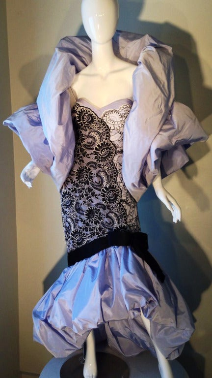 A fine and rare vintage Bob Mackie couture ensemble worn to the Academy Awards 1988. Strapless black and white lace over a ice blue taffeta silk dress with a large sculpted asymmetrical hemline and train plus matching sculpted shrug jacket. A