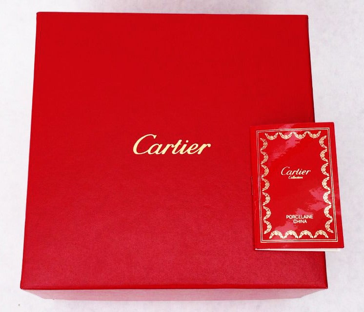 A fine and rare vintage Maison Cartier covered porcelain box. Unused item retains original signature box and certificate booklet.