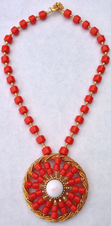 Rare item from the William de Lillo archives. 'Coral' glass and gilt beads suspend a matching pendant with a large genuine angel skin coral cabochon center.

William de Lillo (deceased 2011) emigrated to the United States from Belgium in the