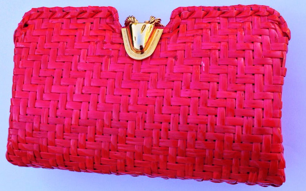 A charming bright red Rodo wicker clutch handbag. Vibrant item features a gilt metal latch closure and pristine interior (appears unused).