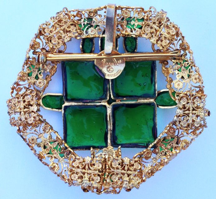 A fine and rare vintage Chanel pendant brooch designed by Robert Goossens. Exquisite signed gilt filigree item features Maisson Gripoix green 