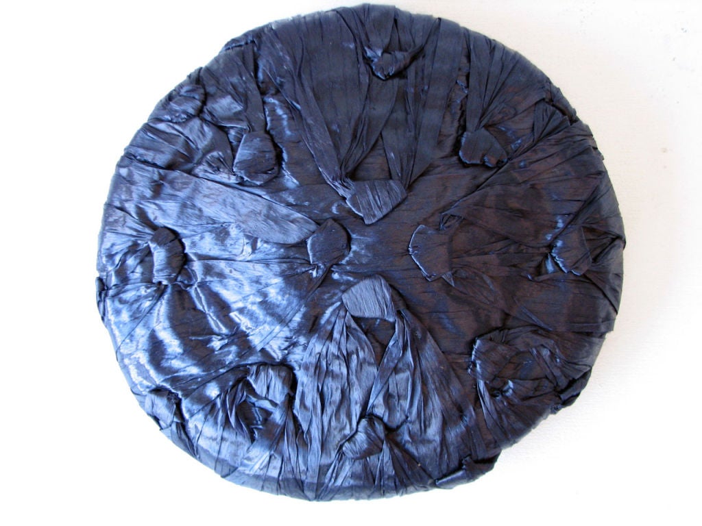 Fine vintage Elsa Schiaparelli straw hat. Finest sculpted midnight blue lacquered straw item. Item retains original attached combs.