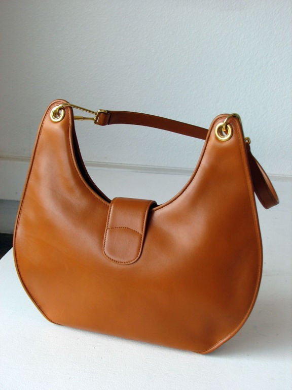 Fine vintage Gucci leather shoulder bag. Authentic 'caramel' leather item with 2 tone gilt metal logo hidden clasp & gilt hardware. Zipper closure with leather interior & single zippered pocket. Strap feature a 13