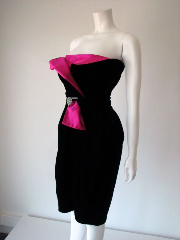 Fine & rare vintage Lanvin 'tulip' belted cocktail dress. Black velvet item features sculpted bright fuschia pink silk satin bodice & double faced 'petals' detail. Matching fabric belt double faced in silk with large crystal set buckle. Item fully