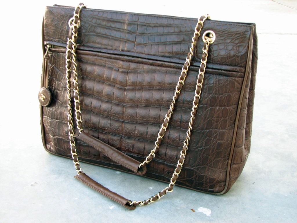 Fine & rare vintage Chanel crocodile shoulder bag. Fully leather lined item features 2 open exterior 'file' pockets, interior zip pocket, gilt metal/leather straps & logo zipper pull. Original signature dust cover intact.