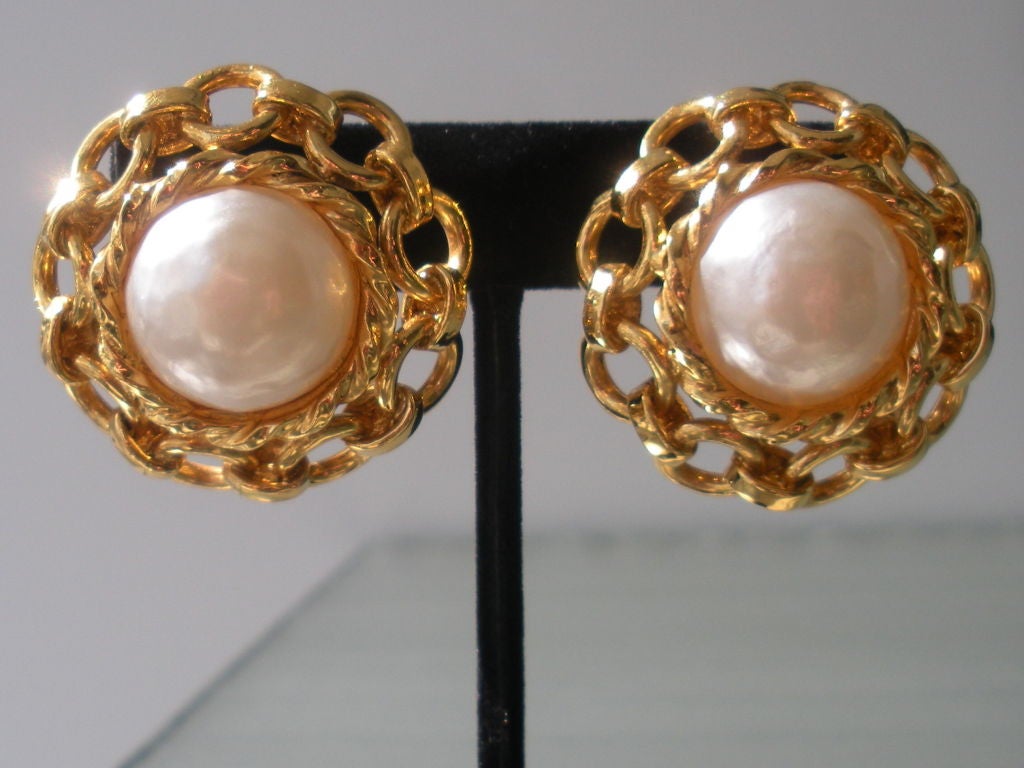 Classic pair of Chanel pearl earrings with chain surround. The clips are stamped made in France- Chanel.