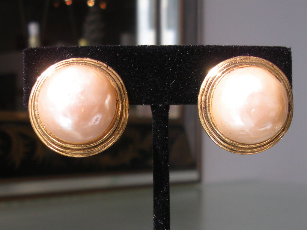 Classic pair of vintage Chanel clip earrings with faux baroque pearl center and Grecian style edge.The earrrings are signed.