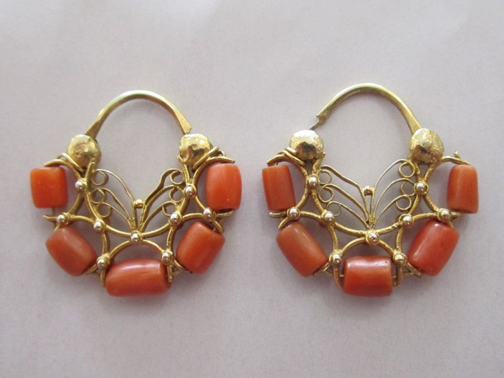 Classic pair of 9k gold and coral hoop earrings made in Oaxaca Mexico-- the coral beads are cylindrical. They are smaller than a quarter in diameter